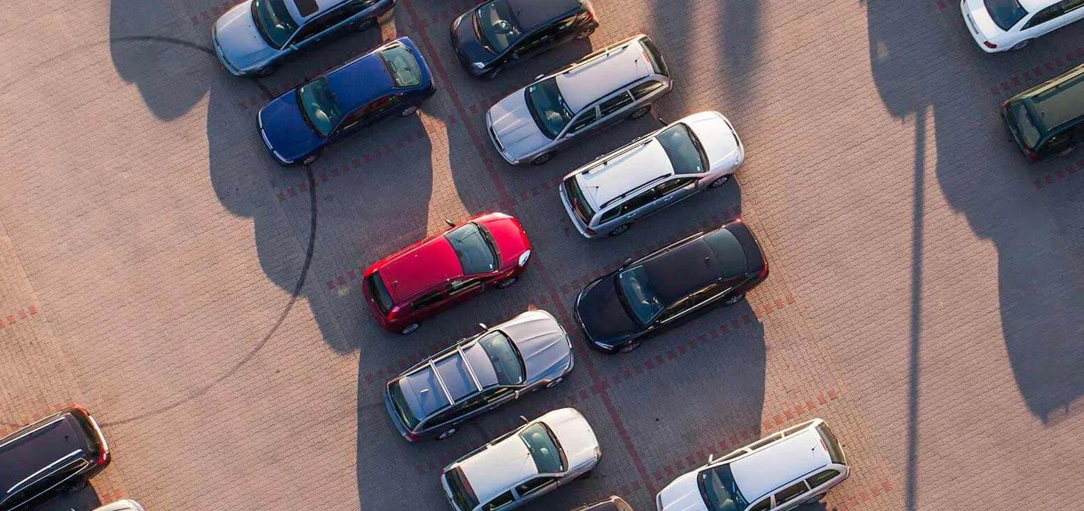 A birds-eye view of a car park full of parked cars