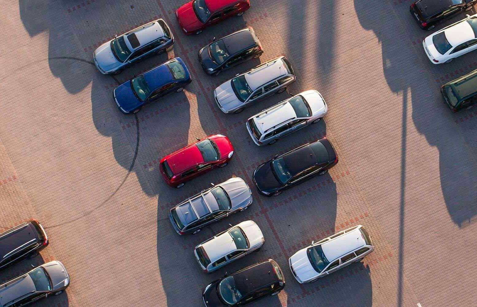 A birds-eye view of a car park full of parked cars