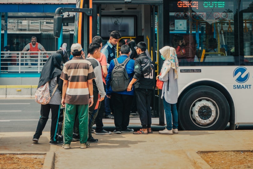 passengers getting on bus