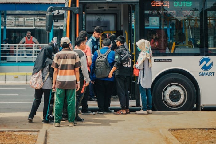 passengers getting on bus