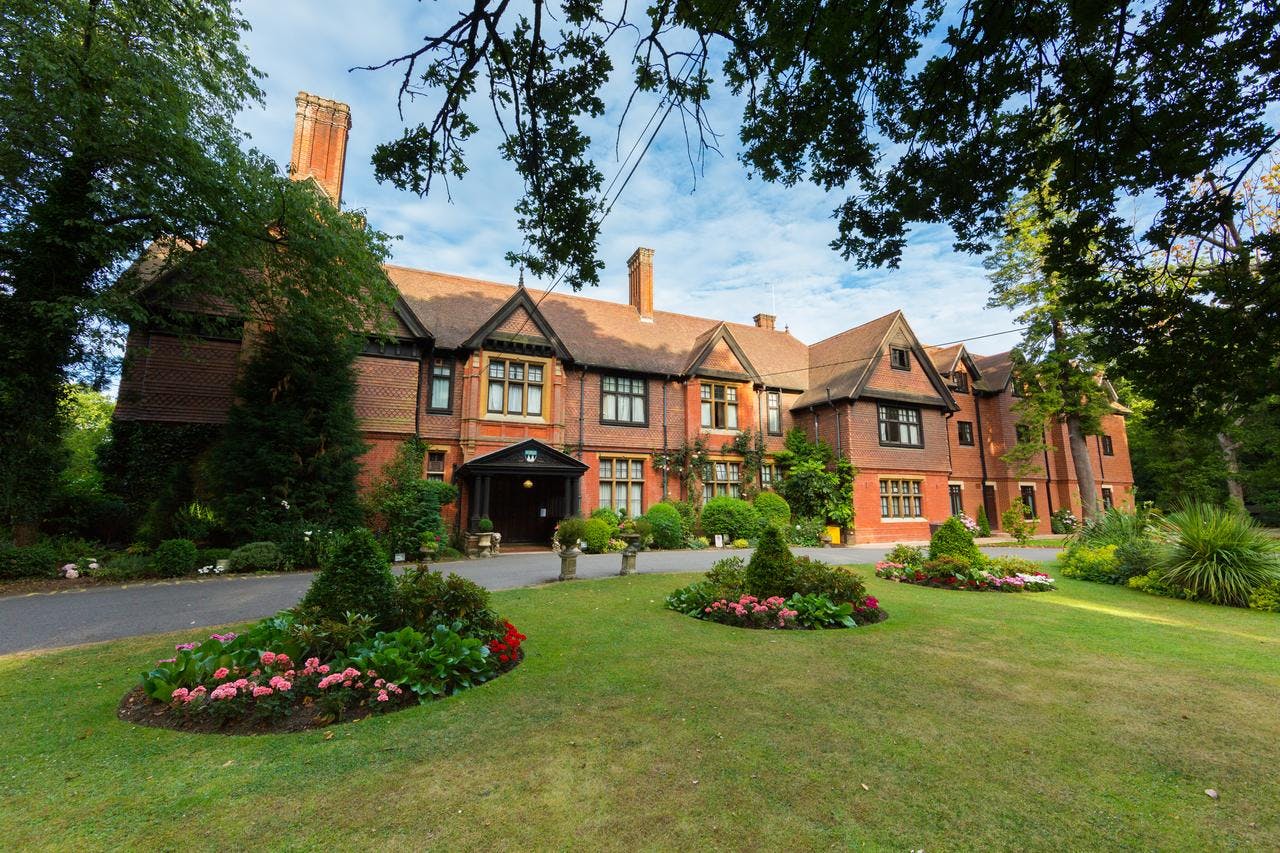 Red brick front and gardens of Stanhill Court Gatwick