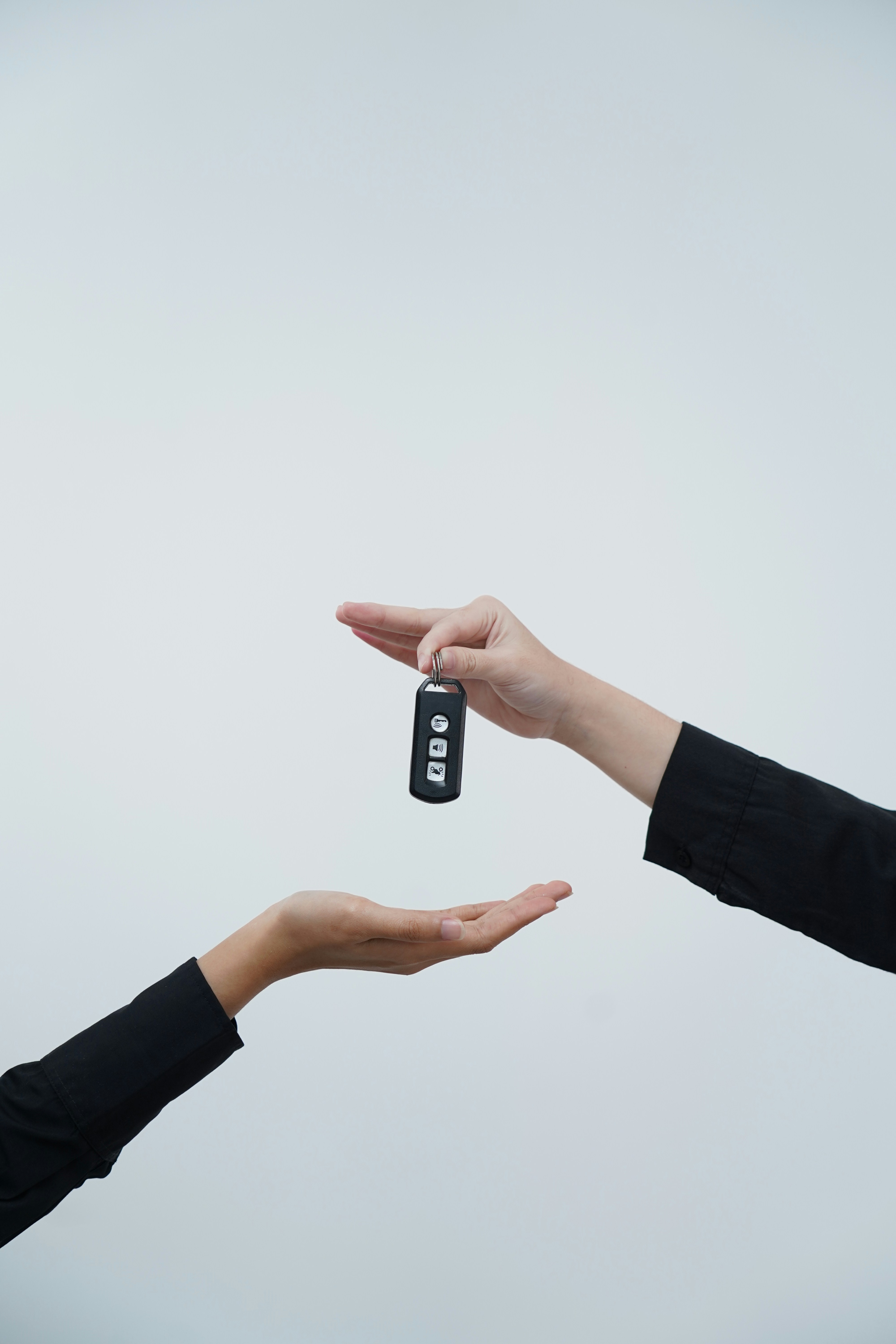 A driver being handed a car key, as happens at a meet and greet handover