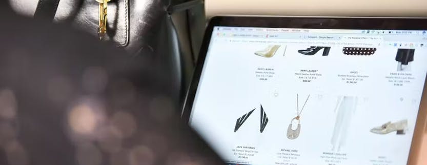 Laptop screen showing products from a luxury fashion brand