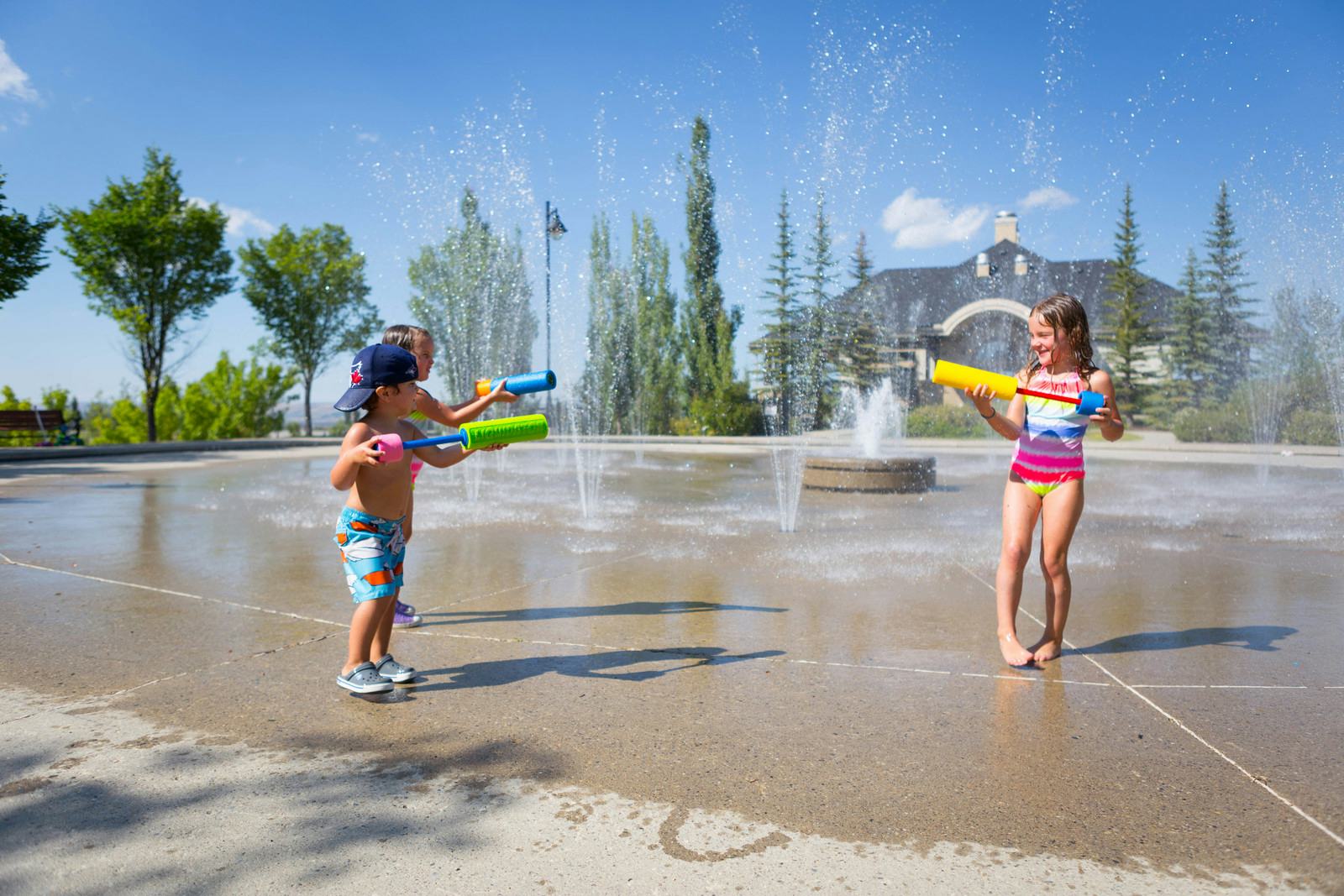 Children playing in a spray park on a summer day