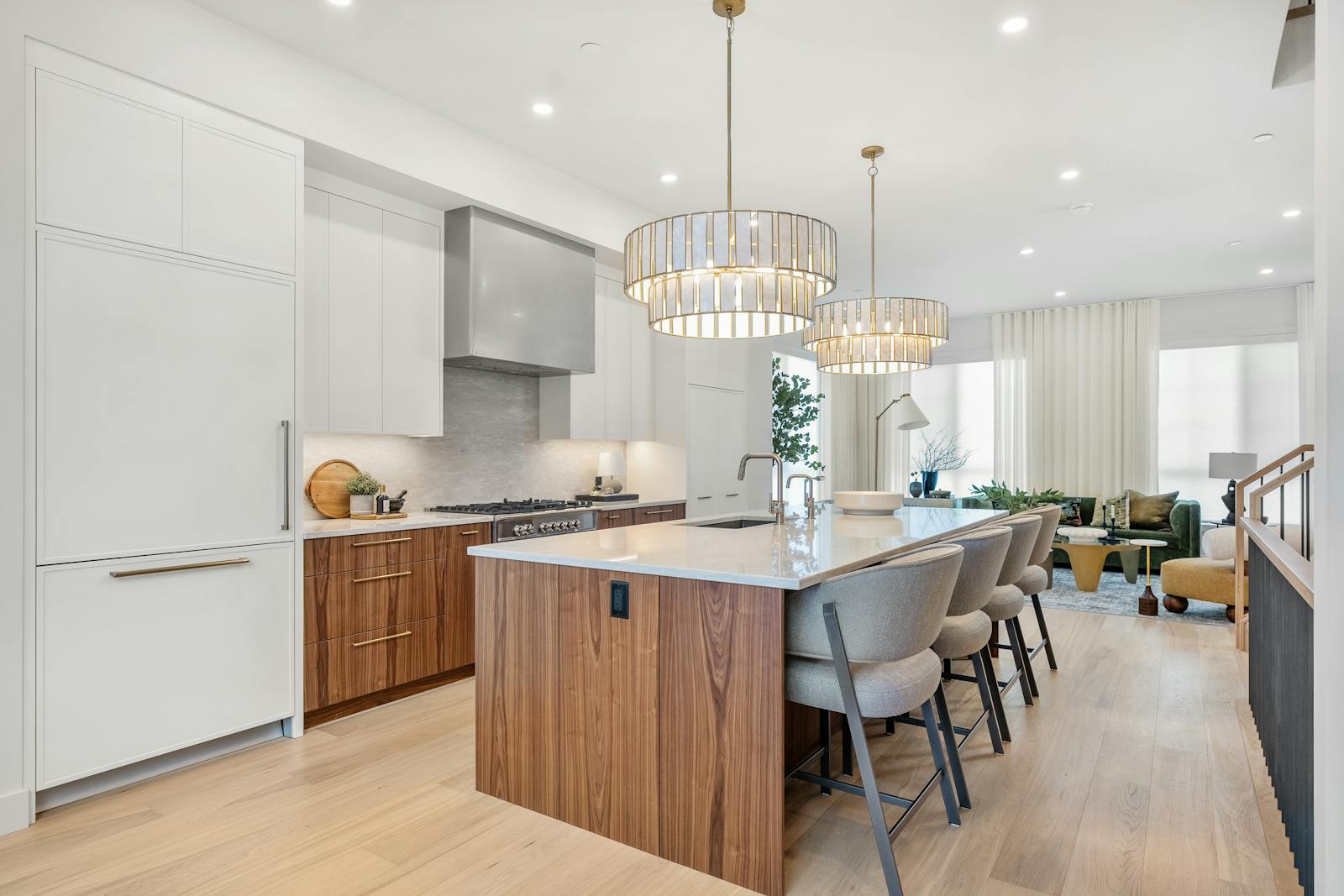 Kitchen area with white walls and two light fixtures over a kitchen island.