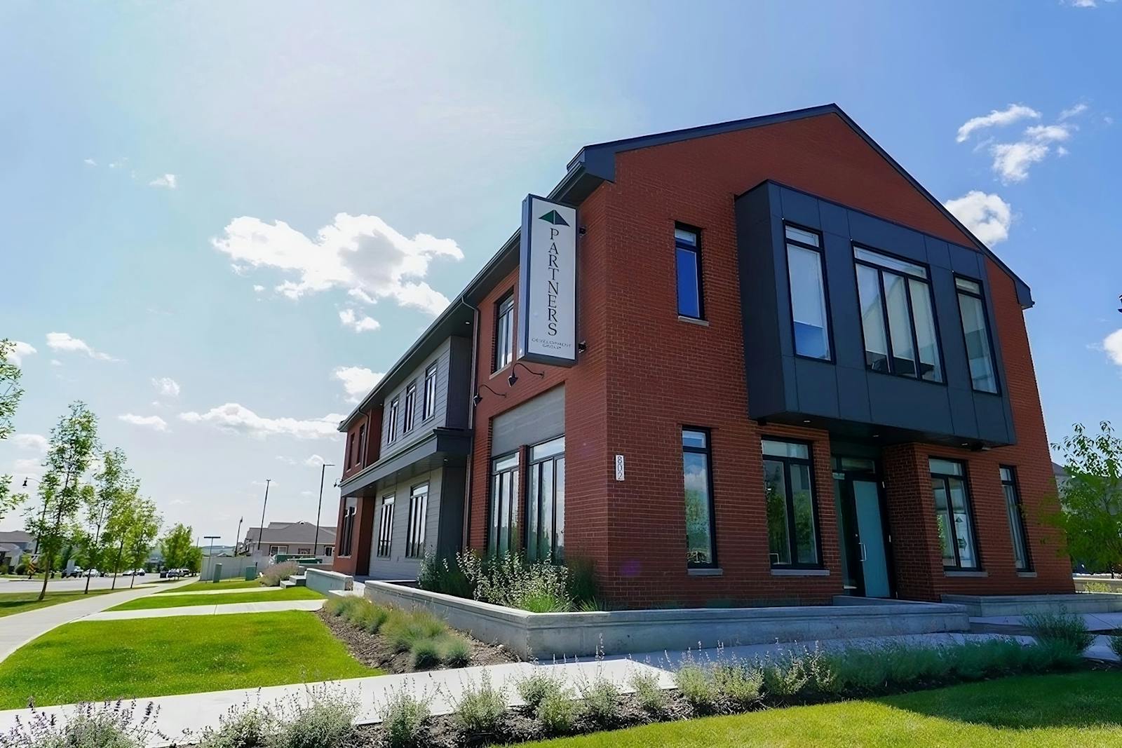 Partners Development Group brick office building under blue sky