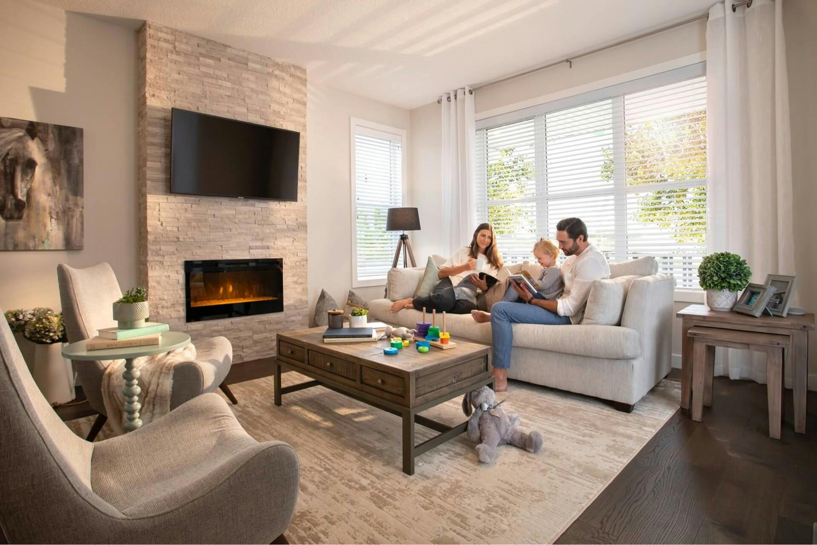 Family reading books on sofa