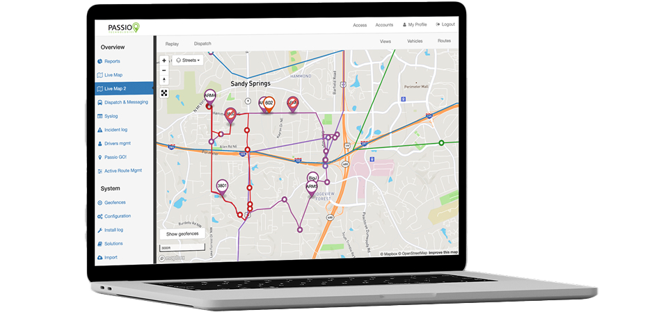 Open laptop displaying the Passio Navigator™ Live View interface, featuring a detailed city map with real-time vehicle routes, stop icons, and tracking tools