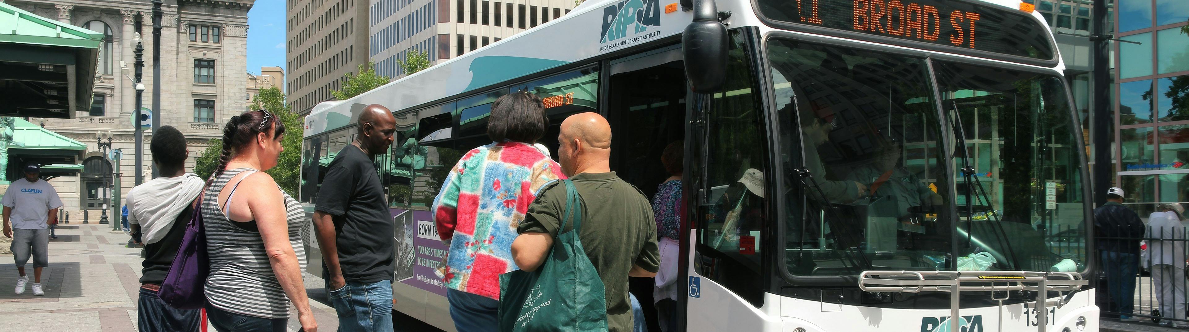 Group of passengers boarding a public transit bus in an urban area, illustrating real-world use of passenger counting solutions for tracking ridership and improving transit operations.