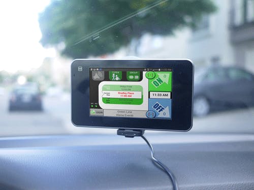 Small touchscreen transit display mounted on a vehicle windshield.