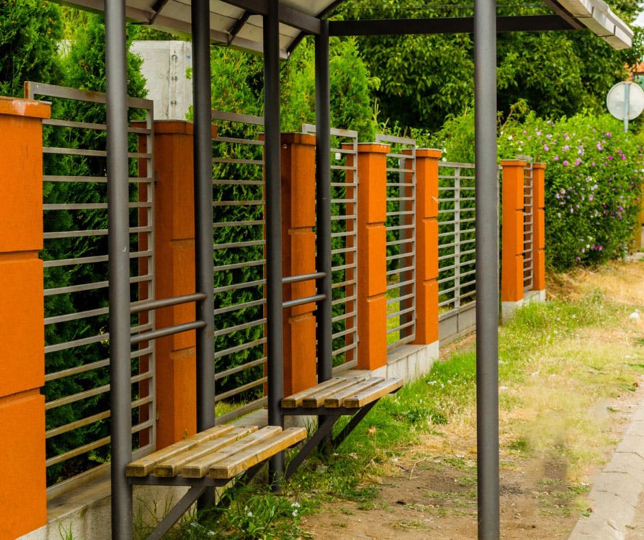 Photo of a bus shelter stop with seating.a