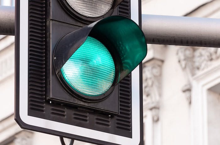 Close up of illuminated green traffic light