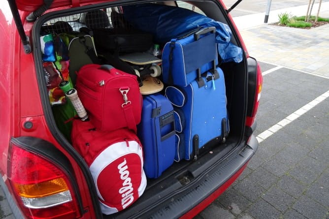 Photograph of a car's boot full of luggage