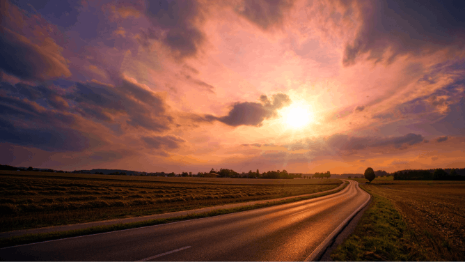 Photograph of a sunset over a country road 