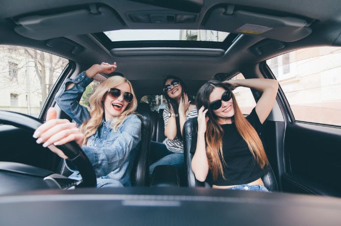 header image showing ladies singing in car