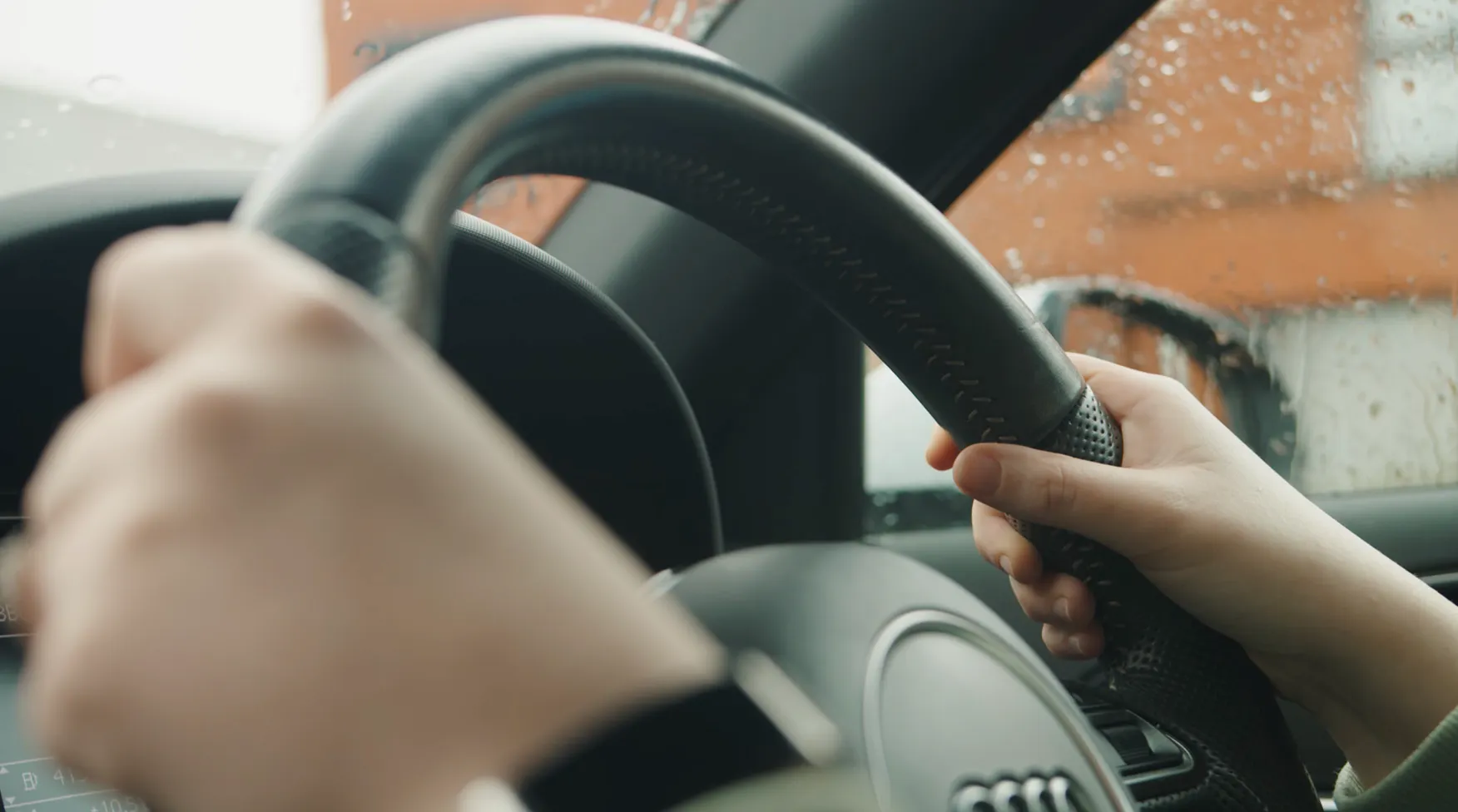 Learner holding a steering wheel