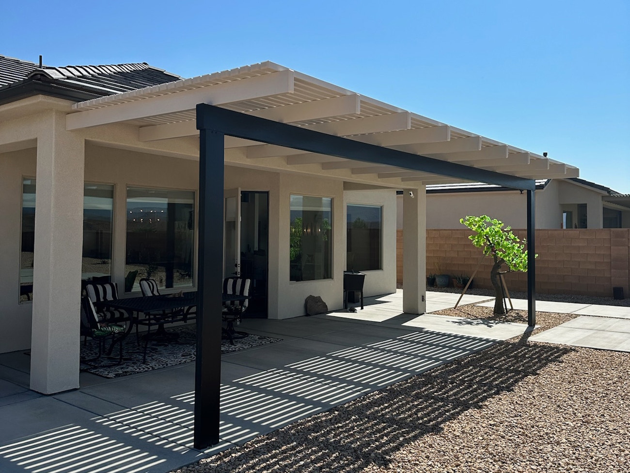 Decorative white and black lattice awning enhancing outdoor space in Las Vegas, NV