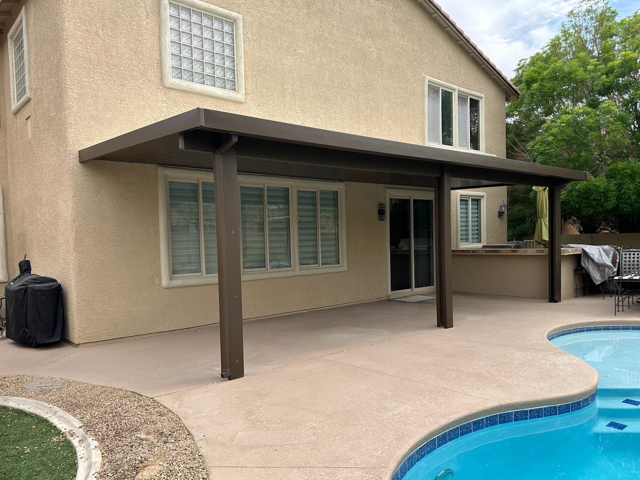 Brown insulated aluminum awning next to poolside installed for Las Vegas home