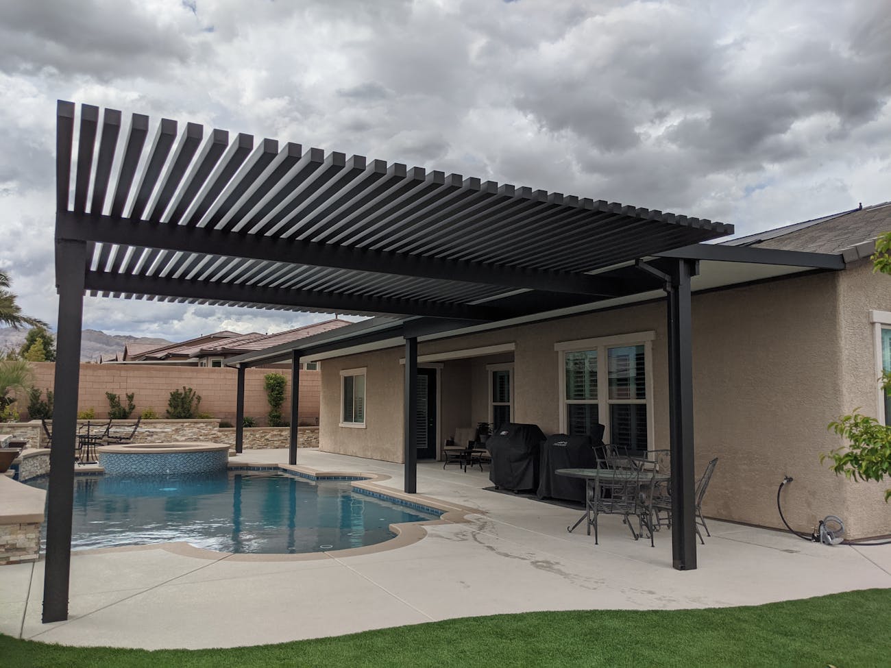 Combination lattice and solid 4K aluminum patio cover by poolside in Las Vegas, Nevada
