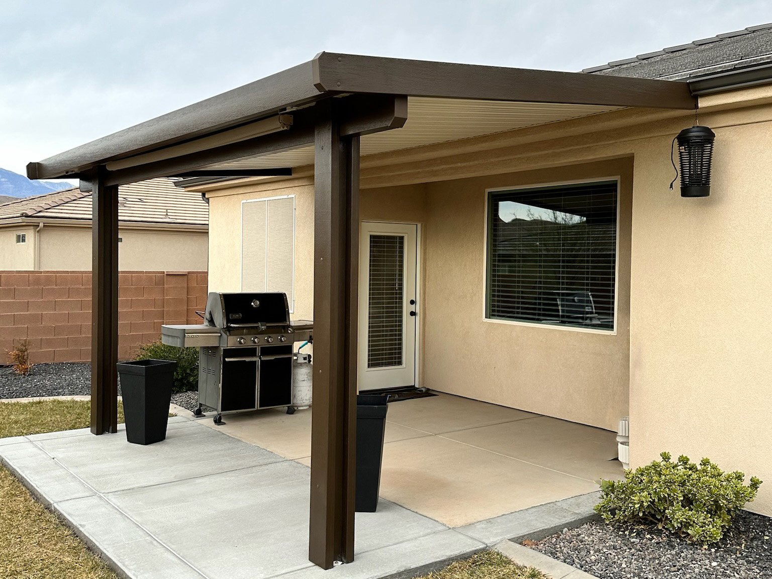Simple brown aluminum patio cover with solid top for Phoenix, Arizona residence