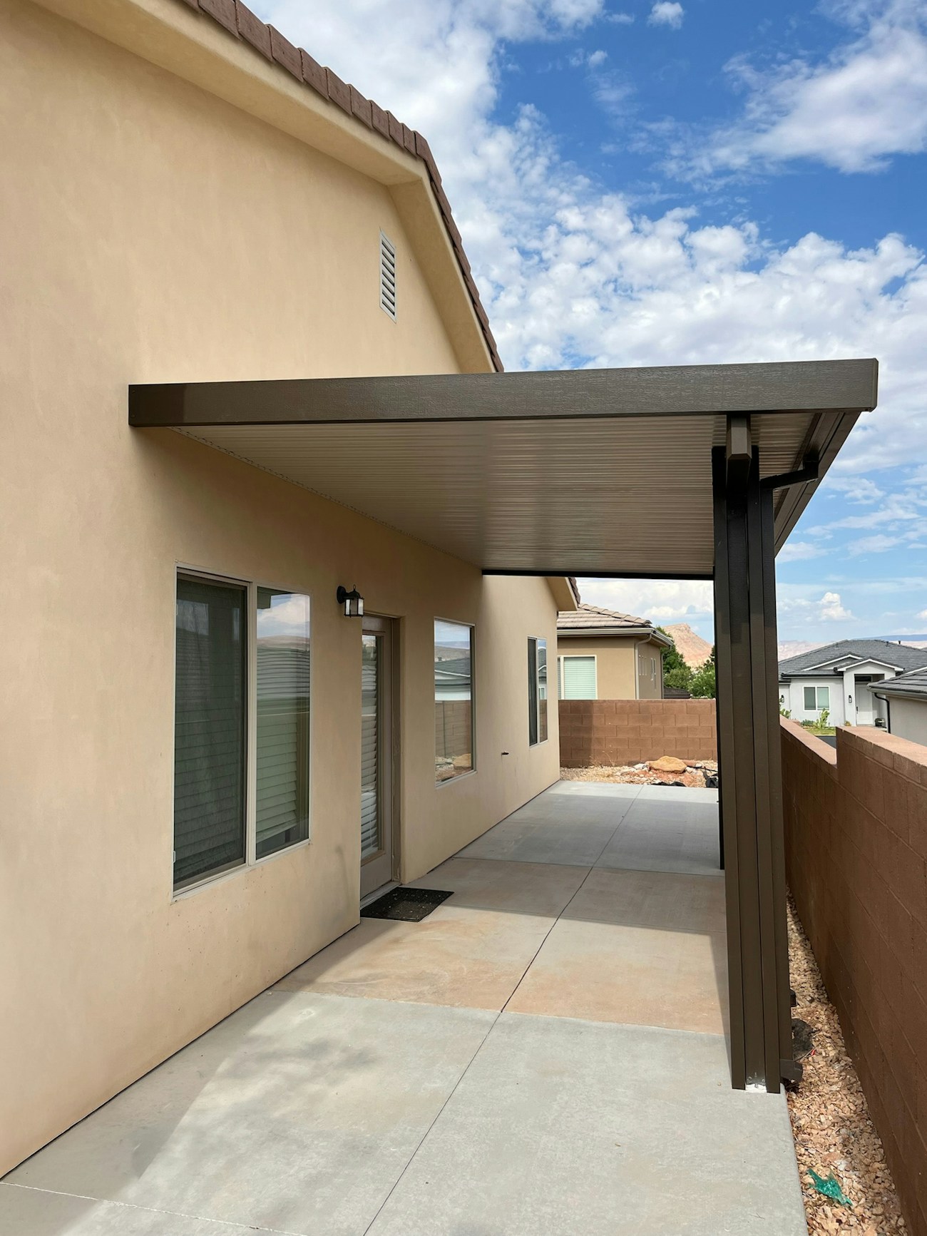 Simple side yard aluminum awning for shade above entryway installed in Phoenix, Arizona
