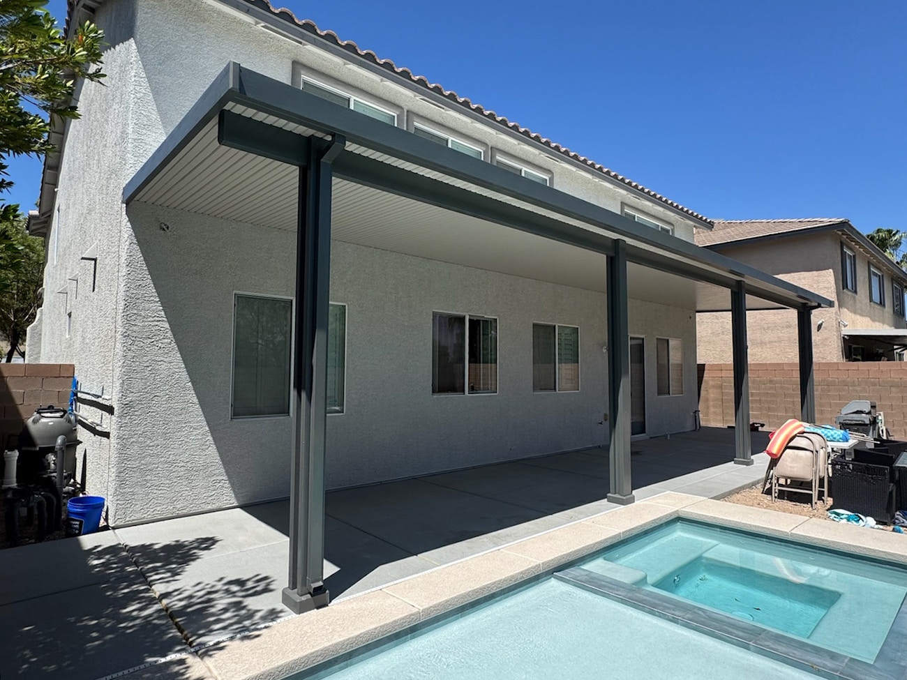 Two tone aluminum patio cover with decorative post bases by poolside in Phoenix, Arizona