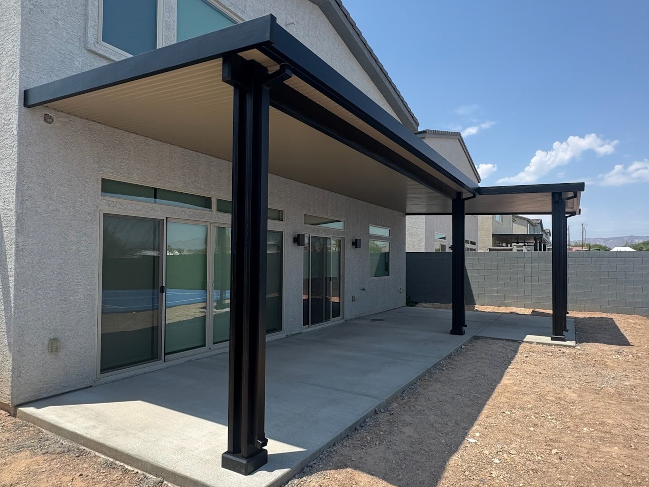 Black solid top aluminum patio cover with white ceiling installed in Phoenix, Arizona backyard
