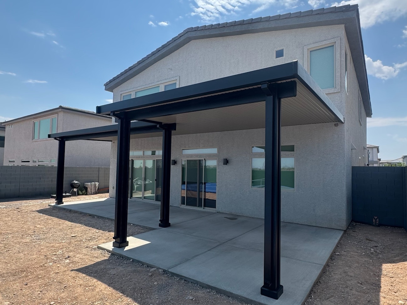 Black aluminum solid roof patio cover awning installed in Phoenix, Arizona
