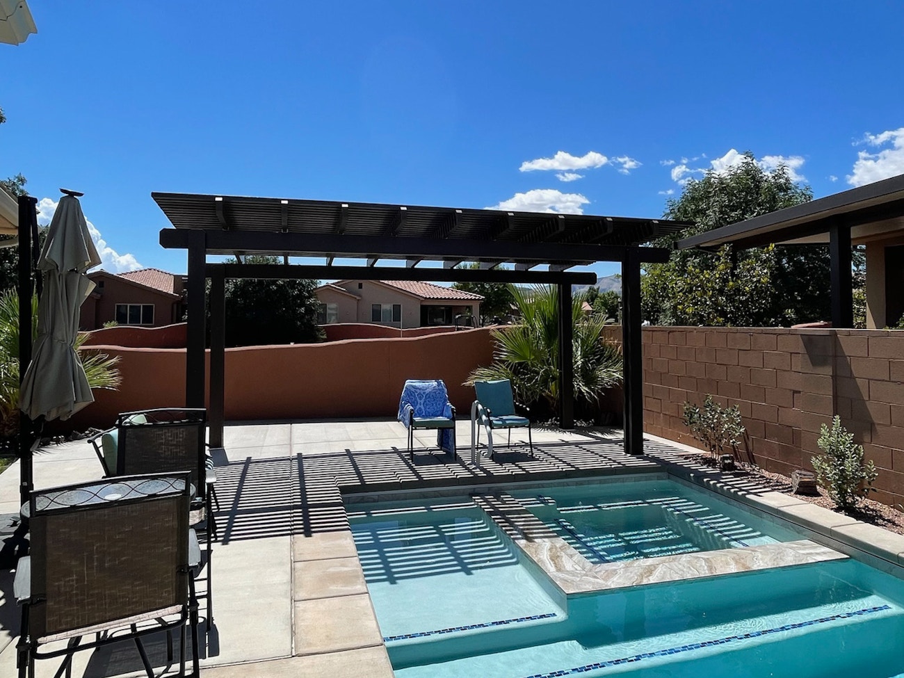 Brown free standing aluminum awning by Phoenix, AZ poolside in backyard