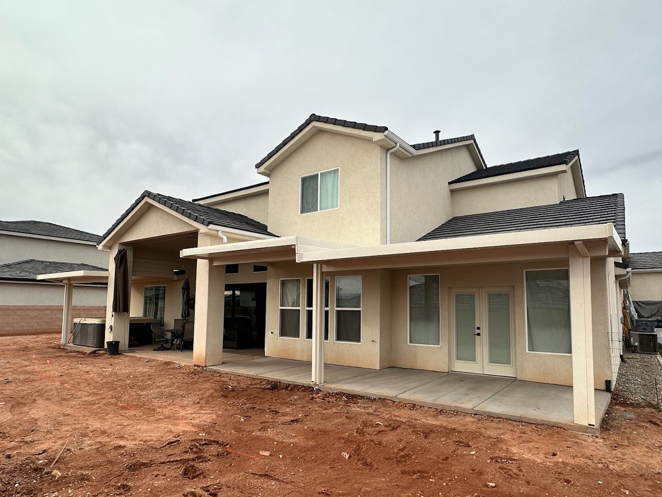 Three white aluminum insulated patio covers protecting back patio from Saint George sun