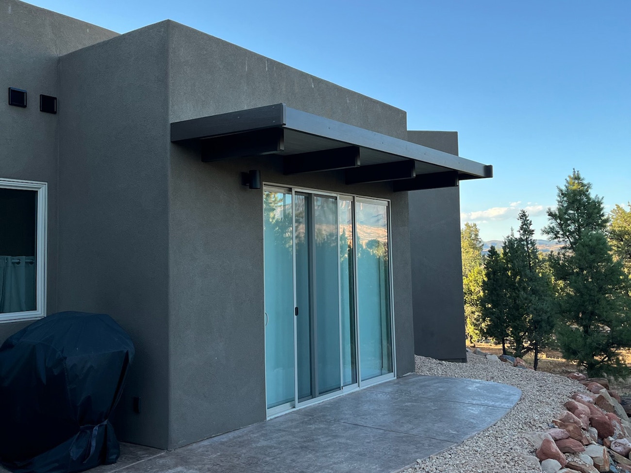 Solid top aluminum awning over sliding glass door providing shade from St. George, Utah sun