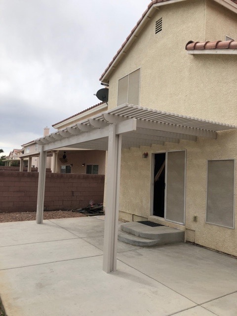 Beige lattice aluminum patio cover for back patio installed in St. George