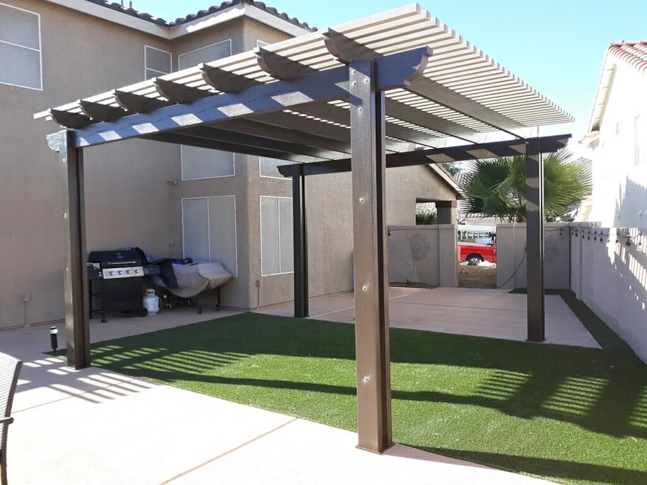 Aluminum lattice cover offering partial shade for Saint George backyard