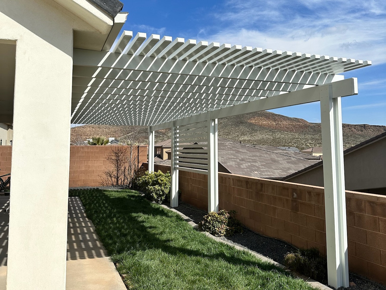 Full length white aluminum lattice cover offering partial shade for St. George, Utah backyard