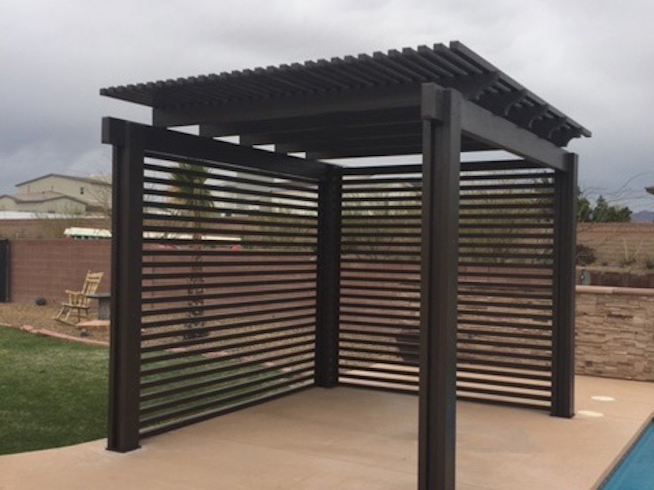 Free standing brown lattice awning featuring a privacy wall on two sides for home in Saint George, UT