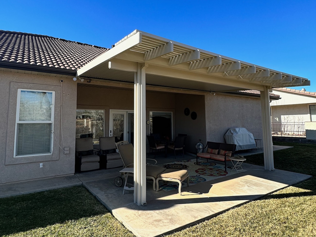 White lattice variable patio cover with partial solid top for St. George home