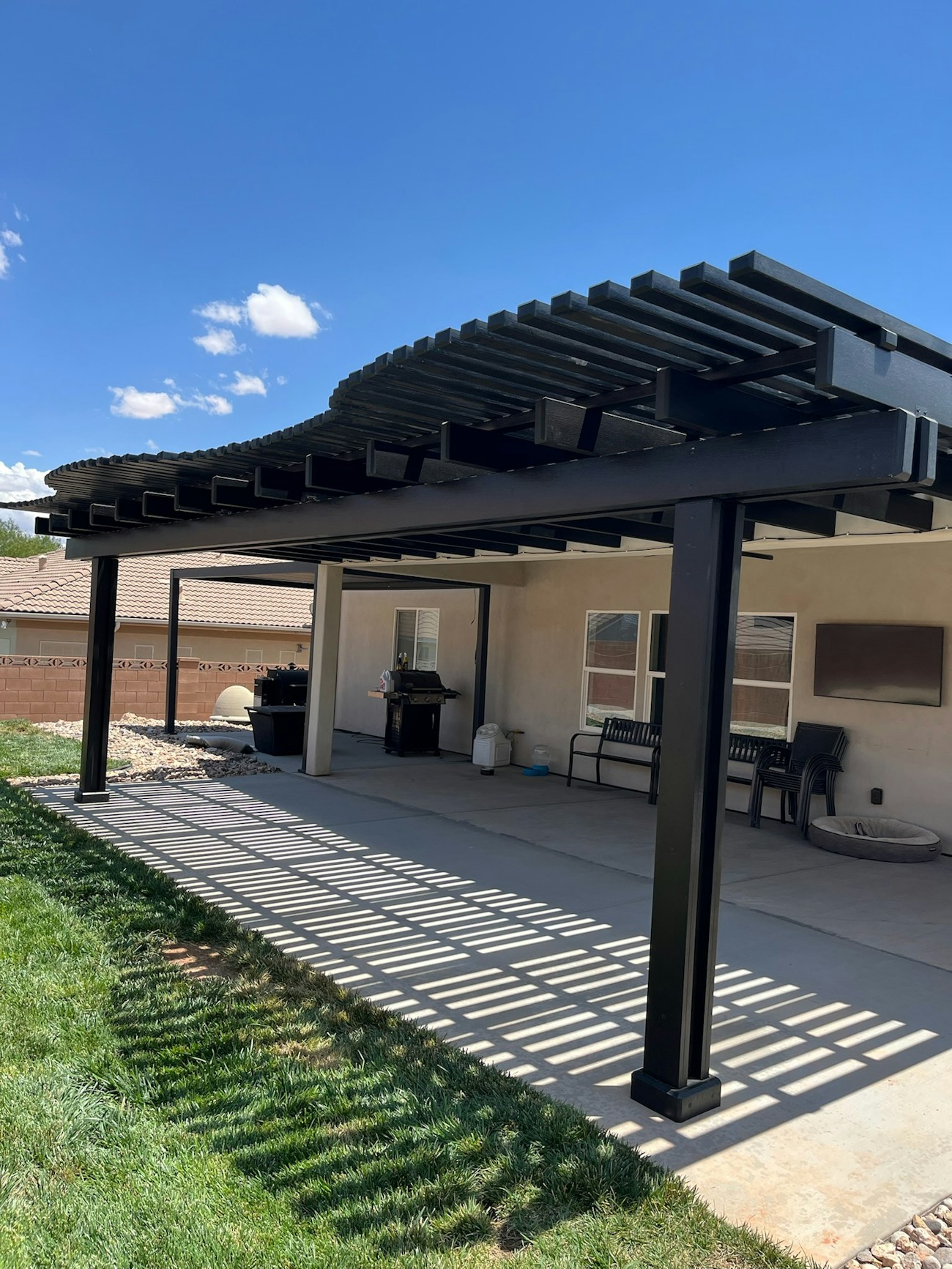 Curved lattice patio cover installed in backyard of St. George, UT home
