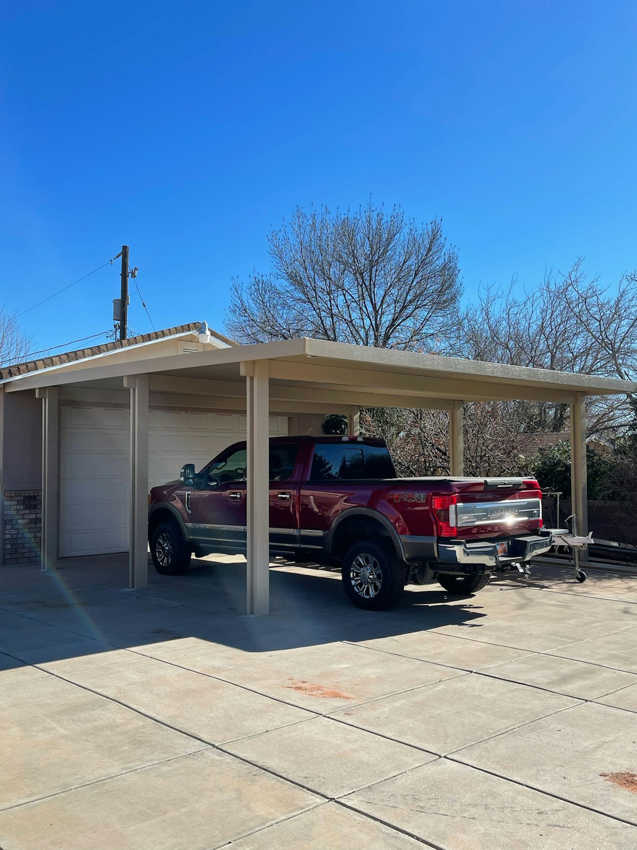 Large aluminum insulated car port in beige for residence in Washington, Utah