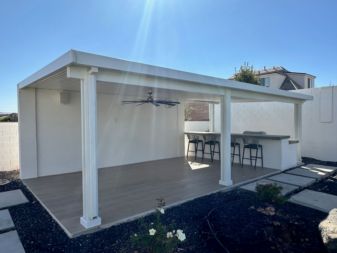 Outdoor ceiling fan attached to free standing awning covering an outdoor kitchen