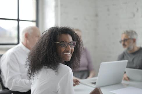 Woman at work smiling at the camera.