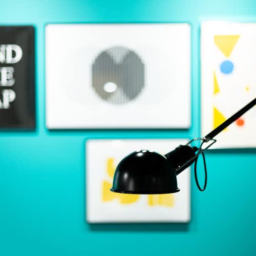 A photo showing a black lamp on a green background.