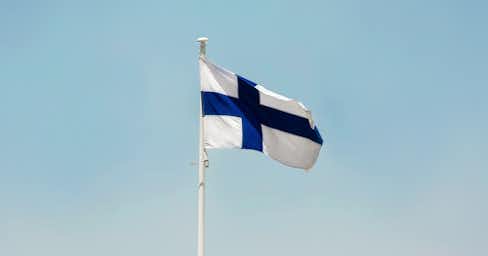 Finnish flag on a blue sky.