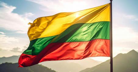 Lithuanian flag with a mountain background.