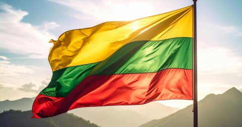 Lithuanian flag with a mountain background.