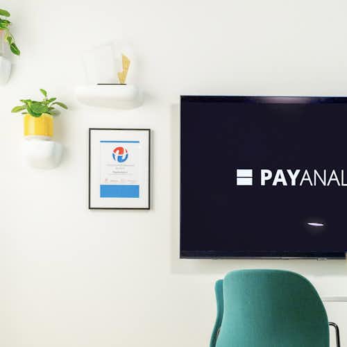 A photo showing a yellow and green chairs in an office space.