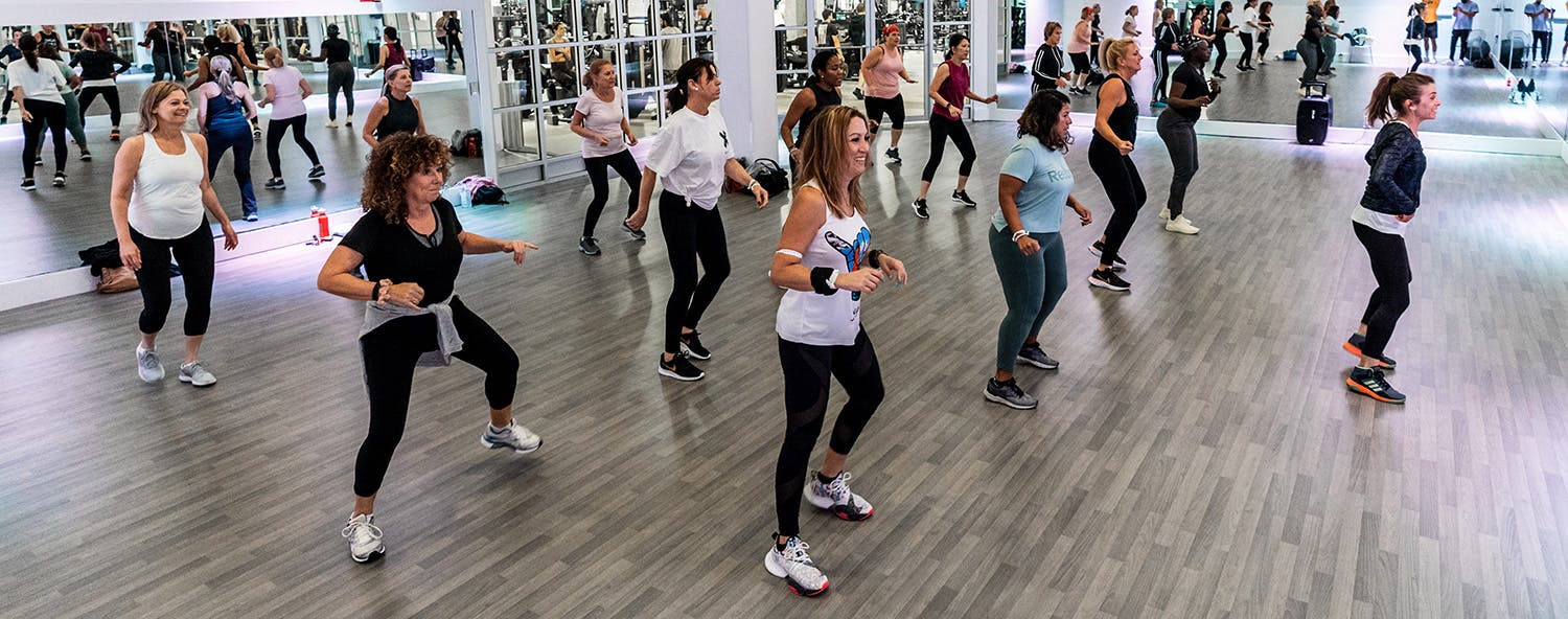 Members participating in a to the rhythm dance class in the studio