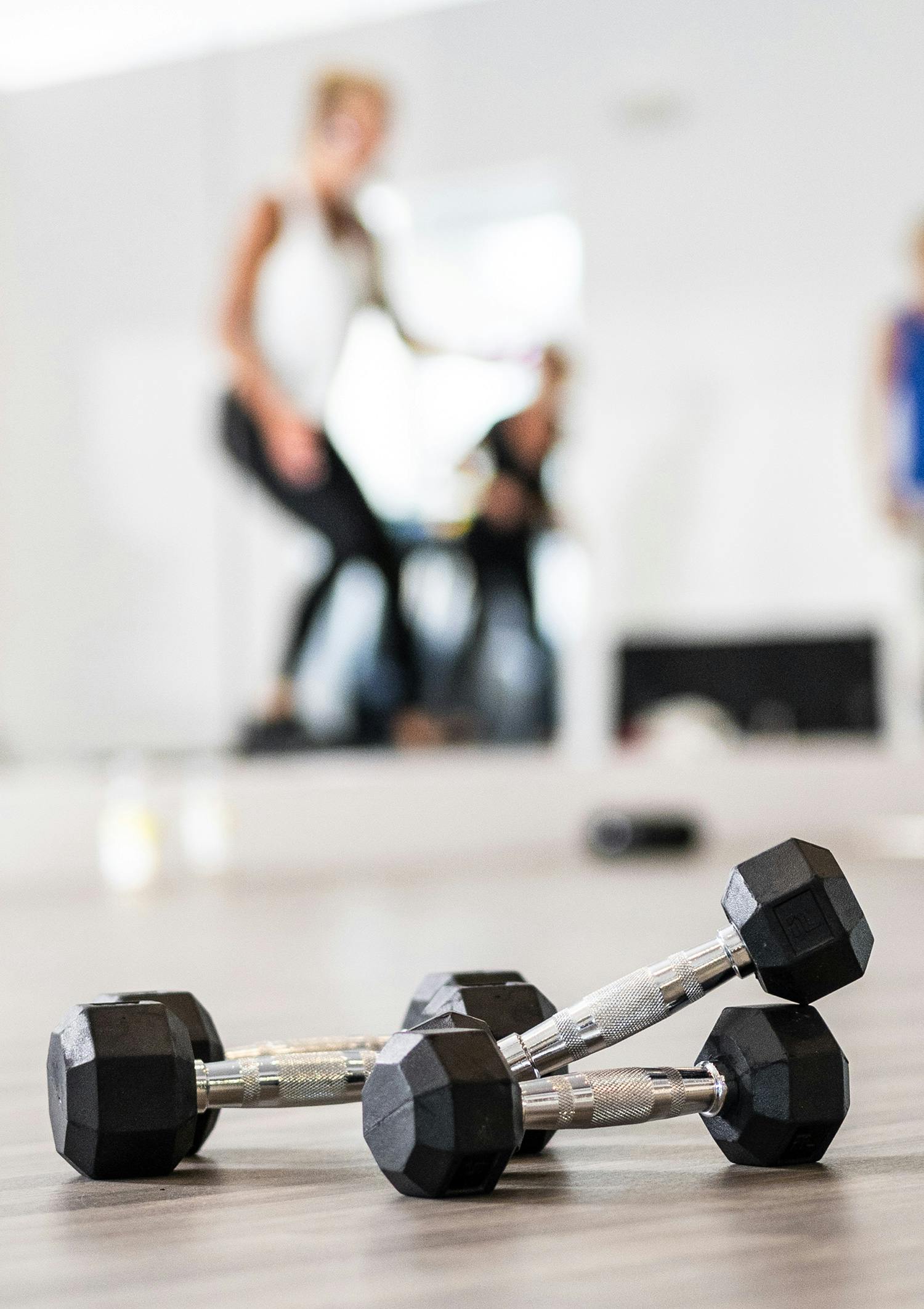 Close-up of weights on floor during interval circuit class