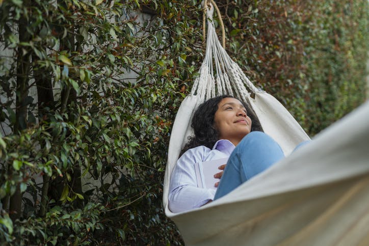 young woman resting self care hammock