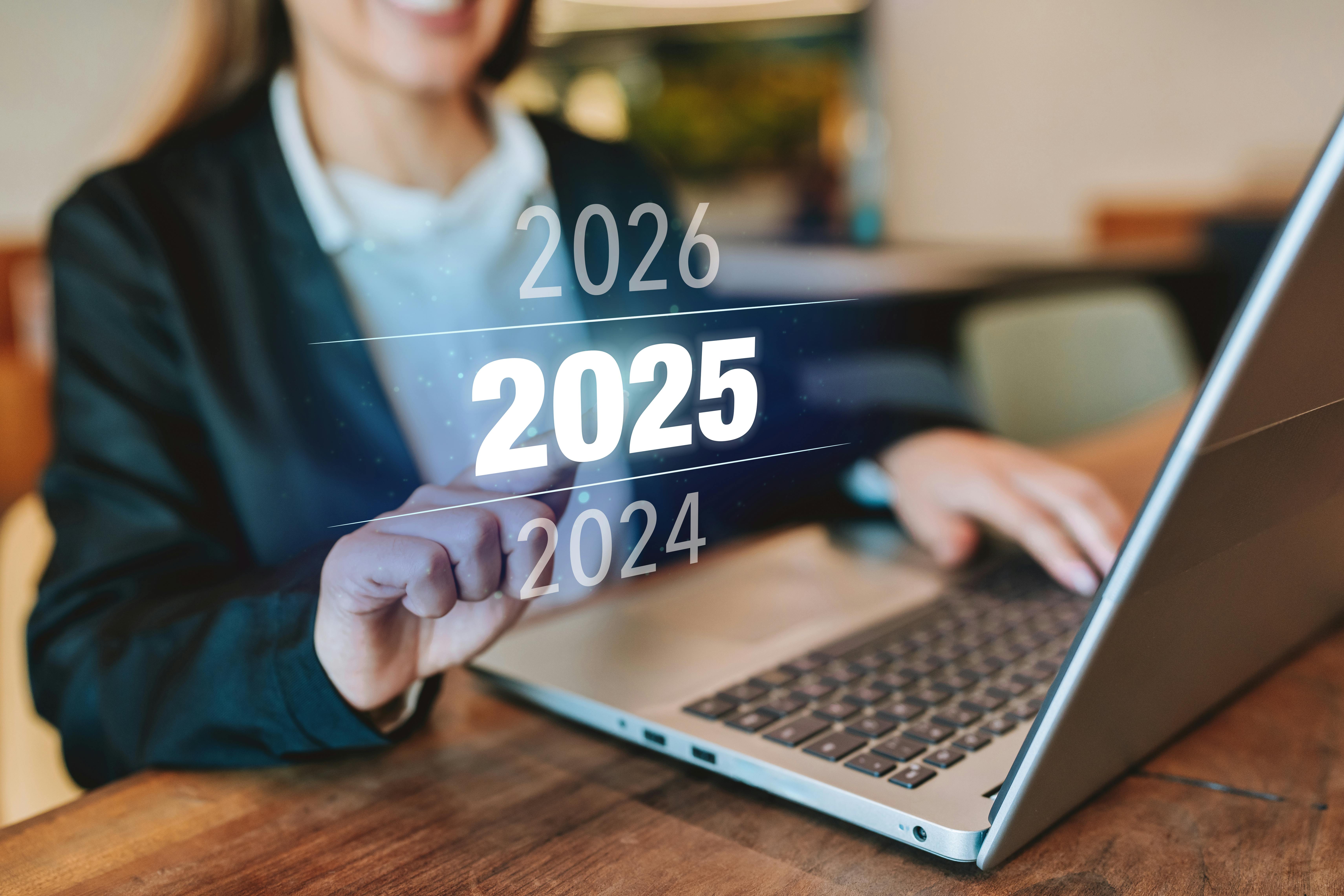 Woman at computer with "2025" in bold