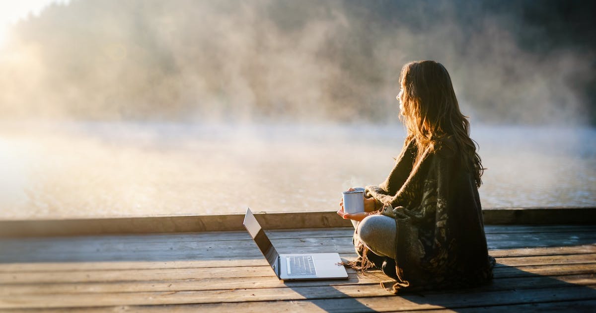 woman reflecting outdoors laptop